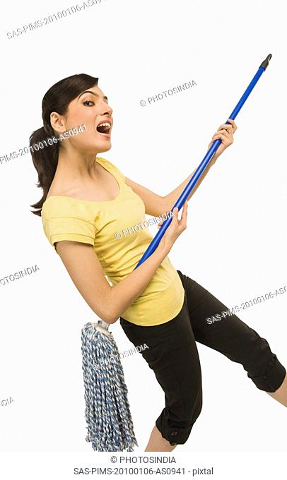 Woman dancing with a mop