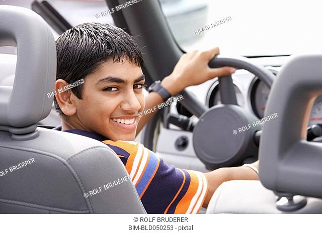 Middle Eastern teenaged boy in car