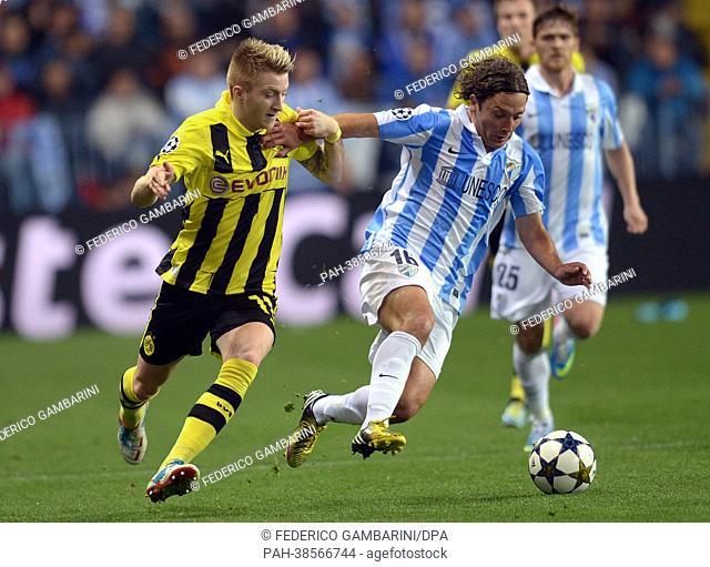 Dortmund's Marco Reus (L) and Malaga's Manuel Iturra vie for the ball during the UEFA Champions League quarter final first leg soccer match between FC Malaga...