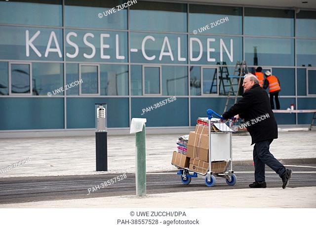 A man transports boxes on a trolly at Kassel Calden Airport in Calden, Germany, 03 April 2013. After one and a half years of planning