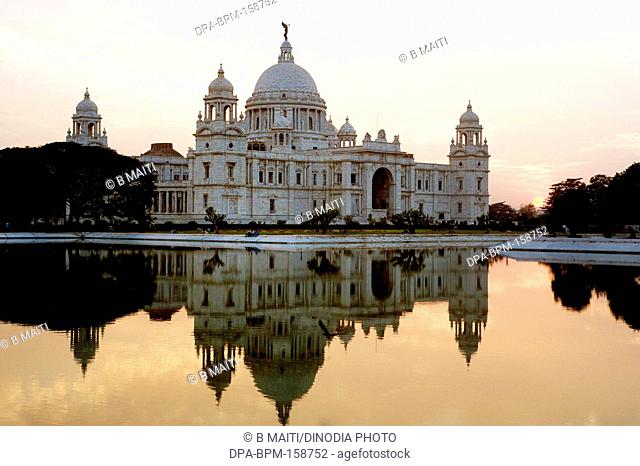 Victoria Memorial reflection in water at sunset ; Kolkata ; West Bengal ; India