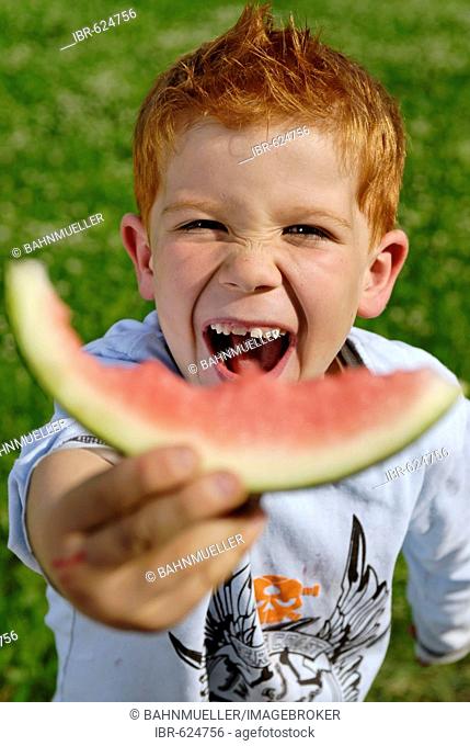 Boy eats a water melon