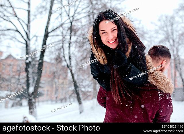 Beautiful young couple having fun in the snowy city