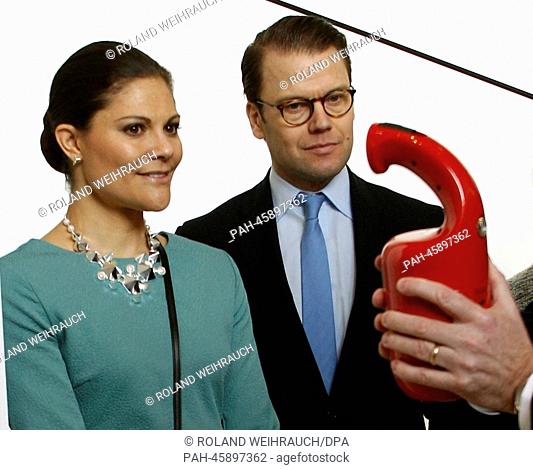 Sweden's Crown Princess Victoria (L) and Prince Daniel look at a Swedish fire extinguisher in the Red Dot Design Museum with museum manager Peter Zec on the...