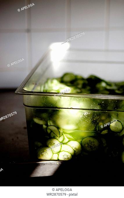 High angle view of sliced cucumbers in container at restaurant
