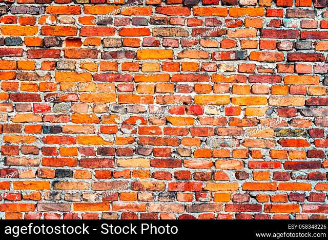 Old, rustic red corroded and damaged brick wall. High quality texture and background for your projects and creative work