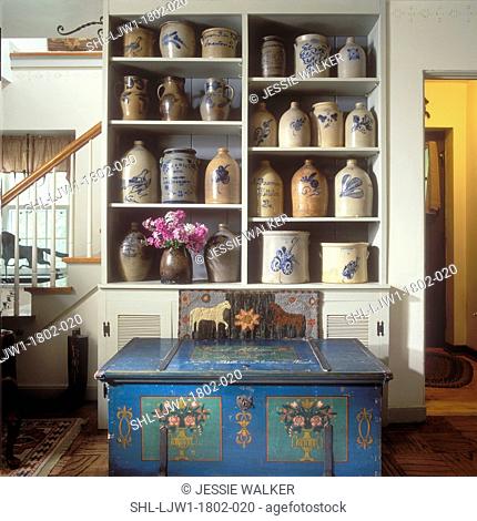 COLLECTION DISPLAYS: Shelves with signed 19th Century Stoneware Collection, hooked rug, 1848 handpainted blue chest in foreground
