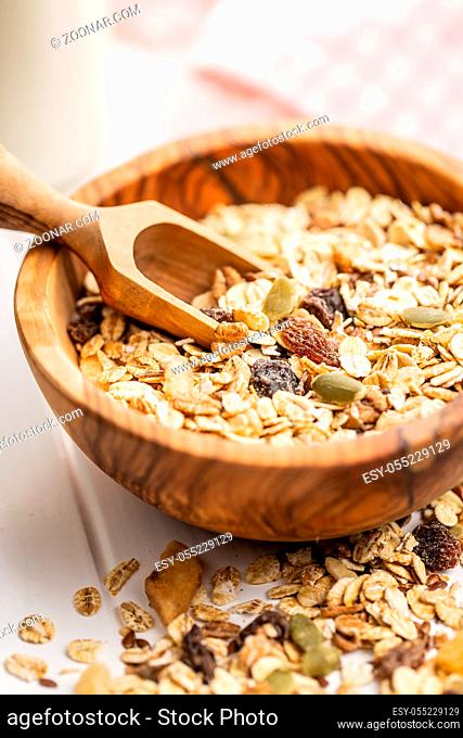 Healthy cereal breakfast. Mixed muesli in bowl on white table