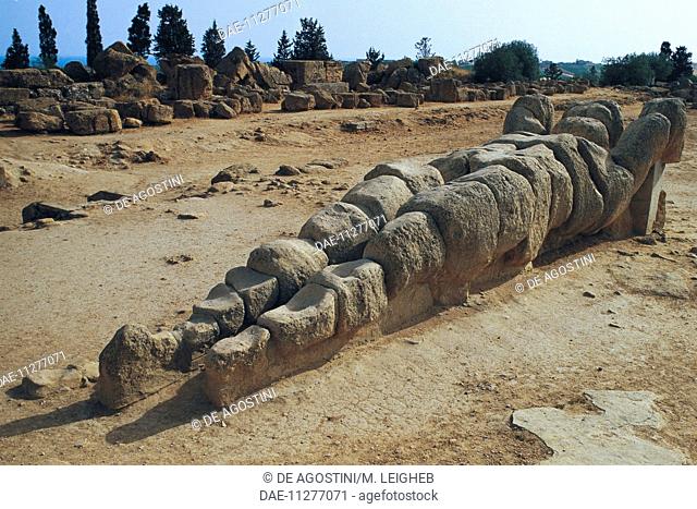 Giant telamon lying on the ground, from the Temple of Jupiter, Valley of the Temples of Agrigento (UNESCO World Heritage Site, 1997), Sicily, Italy