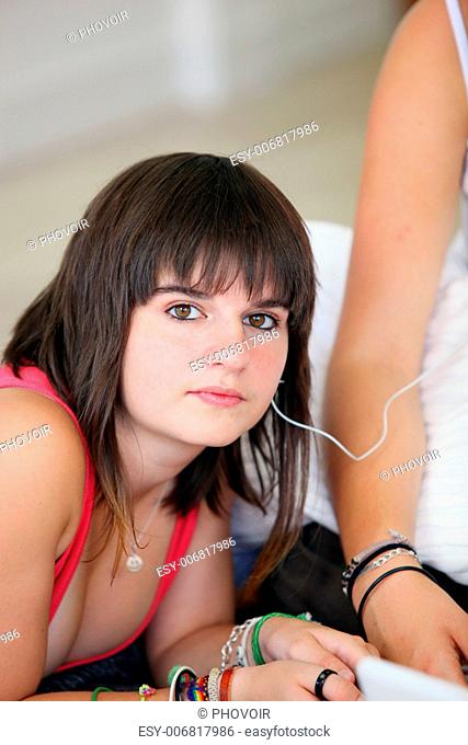 Two teenager sat lat hole listening to music