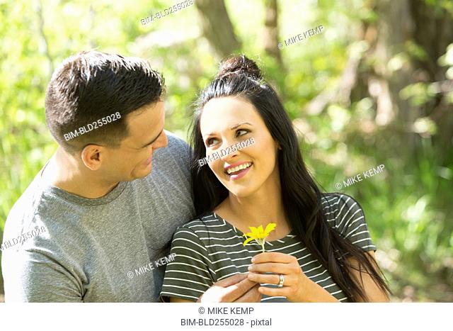 Man giving flower to woman