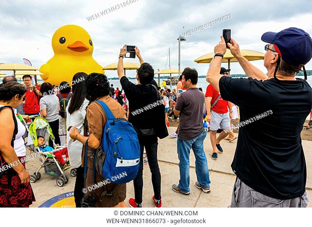 People crowd the HTO Park to take pictures and selfies of the World's Largest Rubber Duck during the Redpath Waterfront Festival as part of Canada 150...