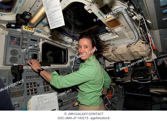 STS-125 Mission Specialist 2 (MS2) Megan McArthur poses for a photo while working the Shuttle Remote Manipulator System (SRMS) from Atlantis' aft flight deck...