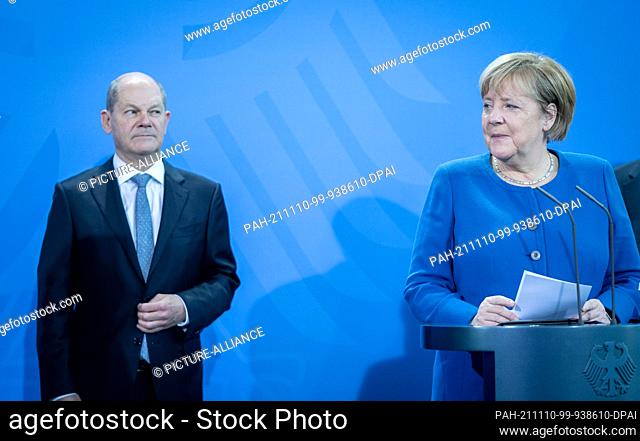 10 November 2021, Berlin: Chancellor Angela Merkel (CDU) turns to Olaf Scholz, SPD candidate for Chancellor and Federal Minister of Finance