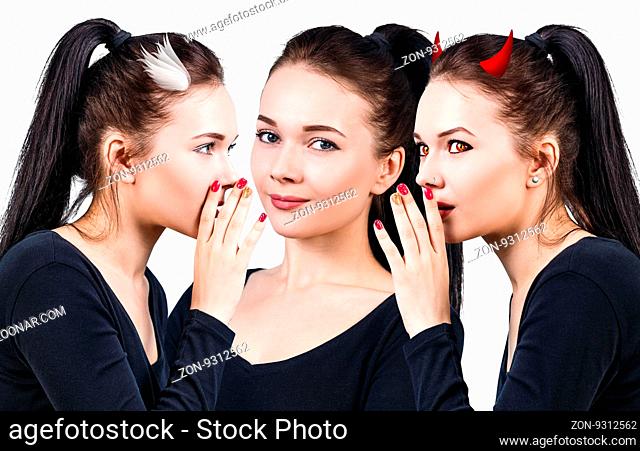 Beautiful young woman with angel and demon whispering isolated over white background