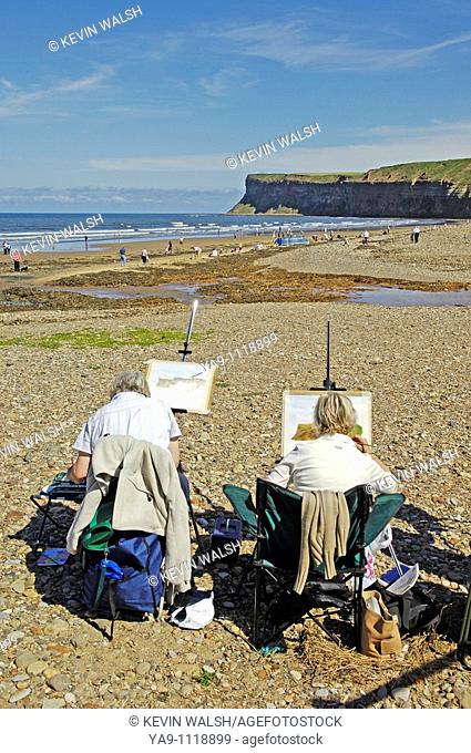 Artists painting on the beach at Saltburn, England