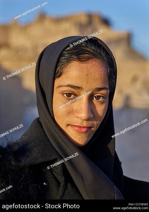 Portrait of a young girl in front of the clay fortress of Bam in southeastern Iran, taken on November 28, 2017. The historic city of plastered mud bricks was...