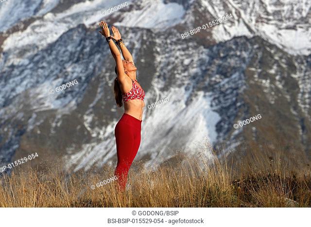 French Alps. Mont-Blanc massif. Woman doing yoga meditation on mountain. Saint-Gervais. France