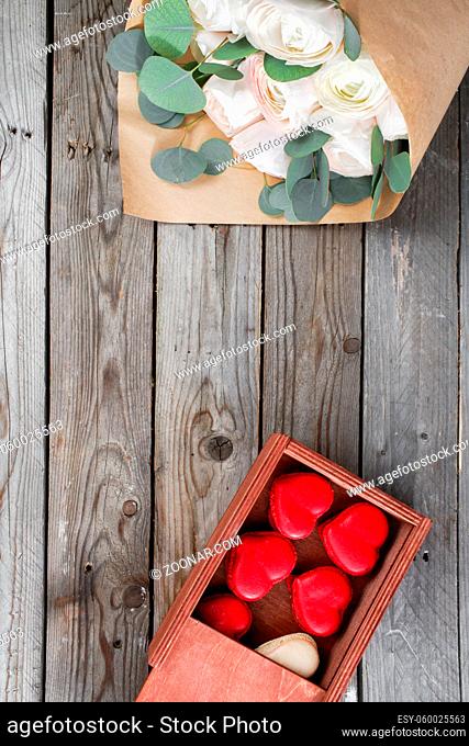Red macaroons desserts and buttercups on wooden background. dessert for breakfast on Valentine's Day. copy space