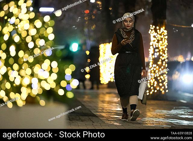 RUSSIA, GROZNY - DECEMBER 19, 2023: A girl is seen in a city street decorated for the upcoming winter holidays. Yelena Afonina/TASS