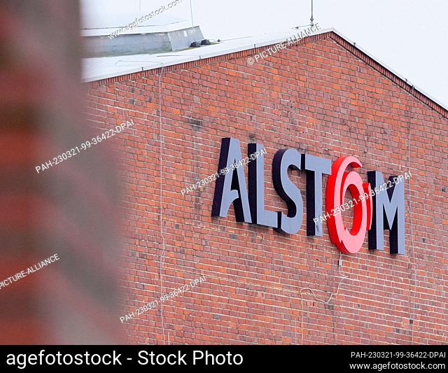 21 March 2023, Brandenburg, Hennigsdorf: The company logo at the main entrance to rail vehicle manufacturer Alstom. The planned cutback of hundreds of jobs at...