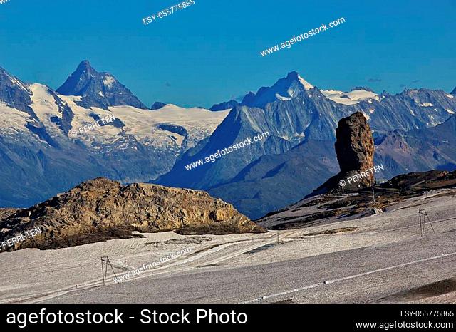 Famous thumb shaped rock named Quille du Diable. Distant view of the Matterhorn. Glacier des Diablerets. Travel destination in the Swiss Alps