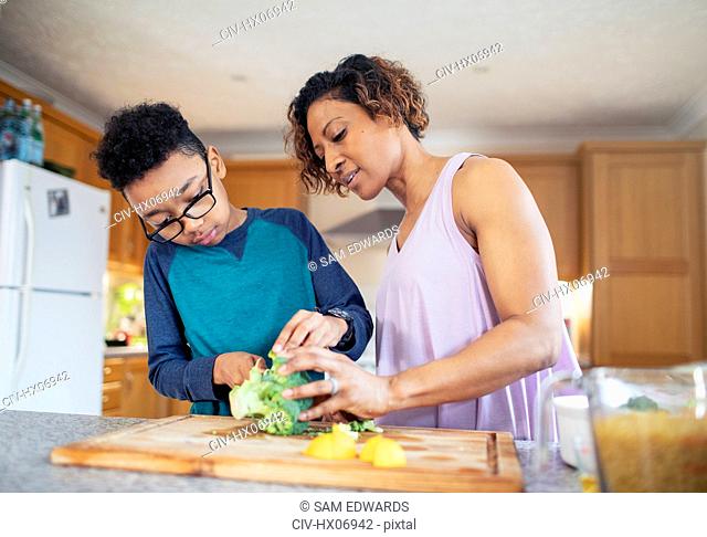 Mother and son cooking in kitchen