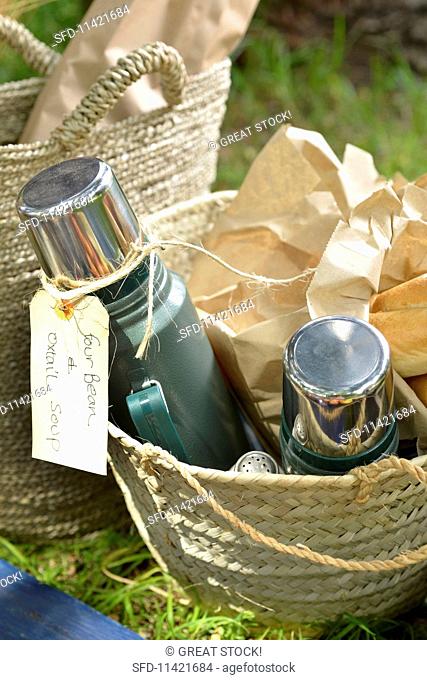 A picnic basket with oxtail soup in Thermos flasks