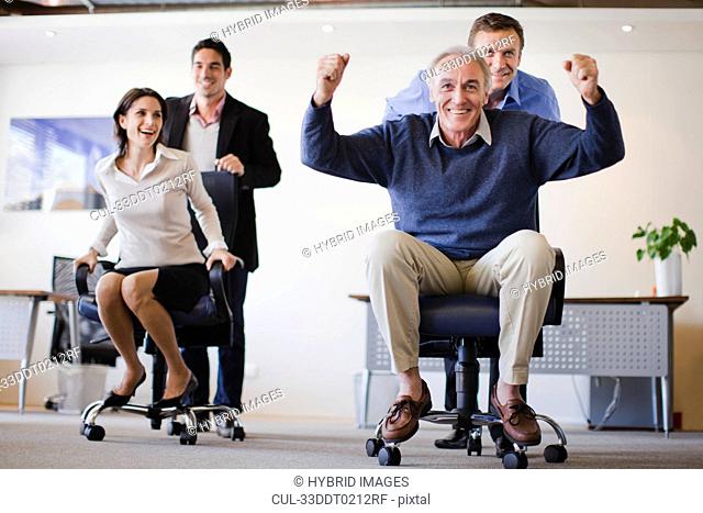 Business people having chair race