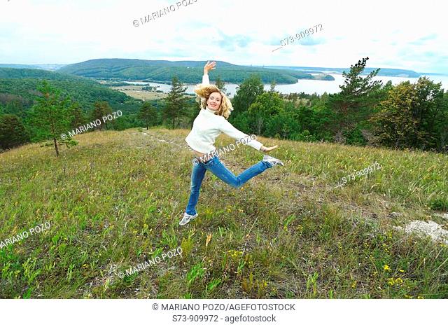 30 years old woman jumping in Molodeskiy Kurgan National Park in Toglyatty, Samara Region, Russian Federation, Russia