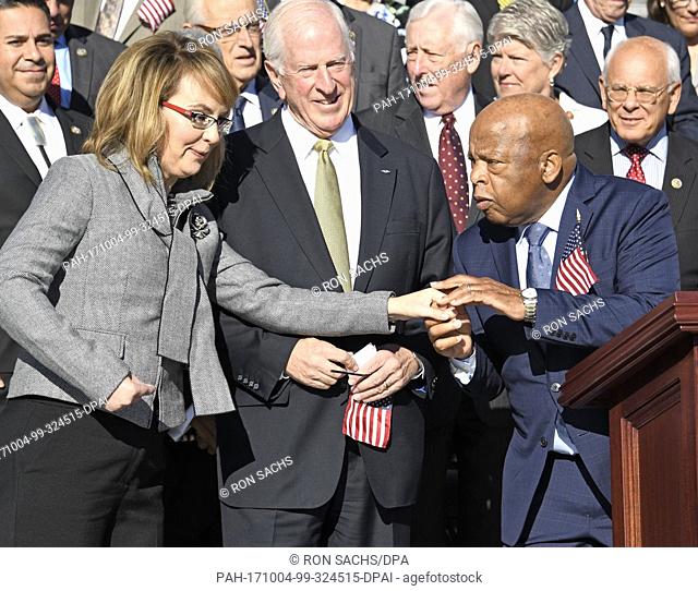 Former United States Representative Gabrielle Giffords (Democrat of Arizona), left is greeted by US Representative John Lewis (Democrat of Georgia), right