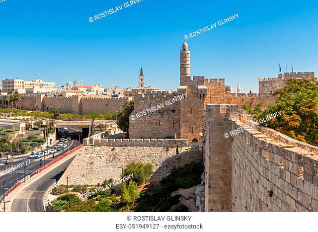 View on ancient walls and old Tower of David under blue sky in Jerusalem, Israel