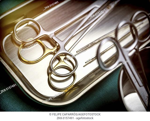 Some scissors for surgery on a tray in an operating theater, conceptual image