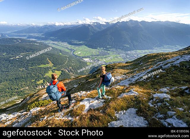 Hikers descending, Inn valley and mountain landscape, ridge walk, Hohe Munde, Mieminger Mountains, Tyrol, Austria, Europe