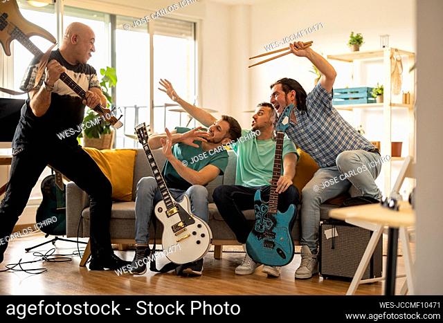 Musicians having fun together in living room at home