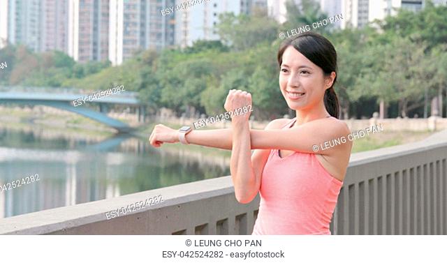Sport Woman stretching hand and listen to music