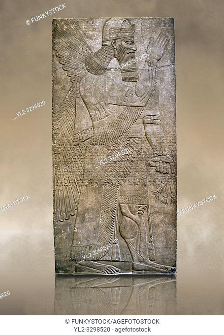 Assyrian relief sculpture panel of a protective spirits holding a bucket of holy water wearing a rosette bracelet which symbolises divine power