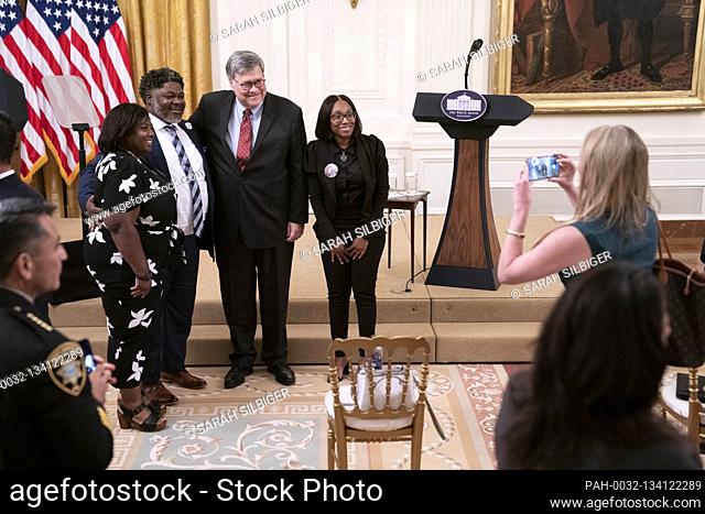 United States Attorney General William P. Barr poses for a photo in the East Room with the family of LeGend Taliferro following remarks from US President Donald...