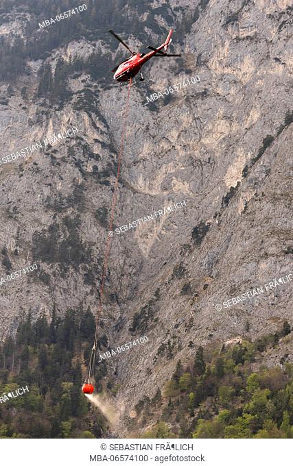 Helicopter of the Ã–AMTC in forest fire-fighting operation near Innsbruck in Tyrol, Austria