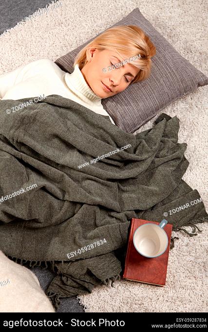Woman sleeping on floor at home