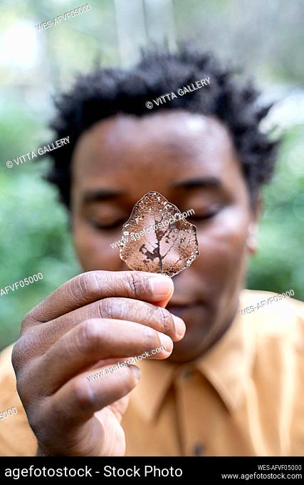 Portrait of mature man holding a autumn leaf