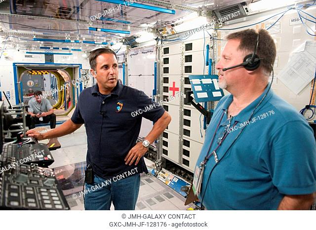 NASA astronaut Joe Acaba (left), Expedition 3132 flight engineer, participates in an emergency scenario training session an International Space Station...