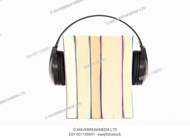 Some books and headphones against a white background