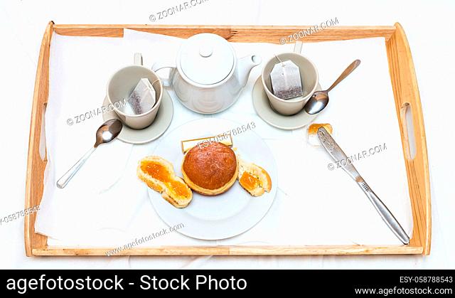 Romantic breakfast tray with fragrant tea fresh baking and jam on white background