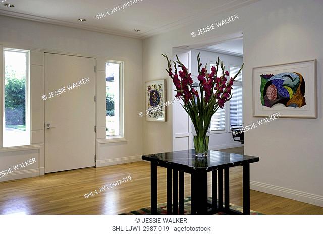 ENTRY HALL, 20thc art work, in contemporay prairie style home, expansive foyer with arts and crafts styled table with arrangement of gladiolas facing front door