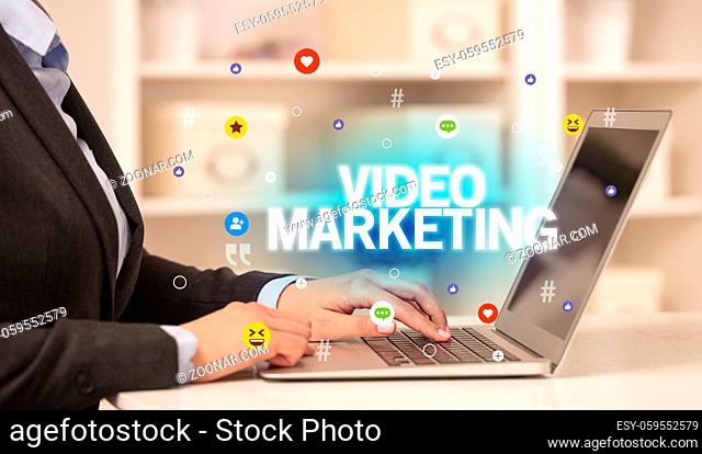 Freelance woman using laptop with VIDEO MARKETING inscription, Social media concept