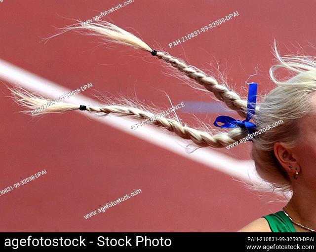 31 August 2021, Japan, Tokio: Paralympics: Track and Field, Women's 100 Meter Preliminary Heat, at the Olympic Stadium. Her blonde pigtails fly as Orla...