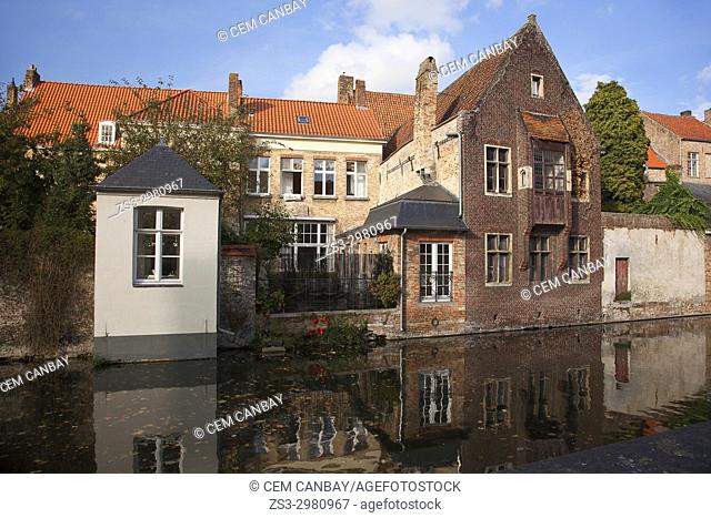 Traditionals houses and their reflections by the canal in the city center, Bruges, West Flanders, Belgium, Europe