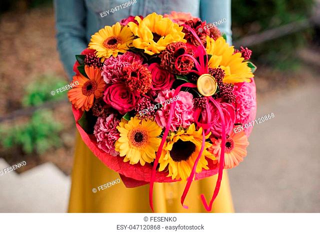 girl holding colorful bouquet with different Gerbera flower composition