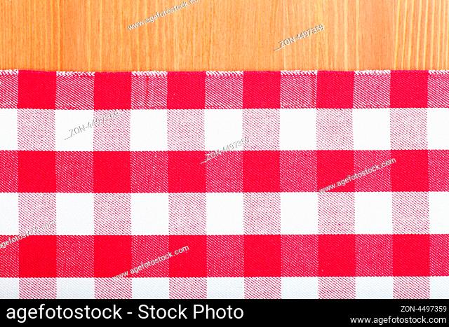 Checked with red and white tablecloth on a wooden table